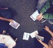 students holding iPads and collaborating