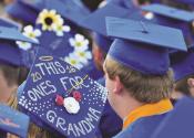 GARY ALLEN - Grads decorated their mortar boards with all manner of accouterments for Friday's ceremony.
