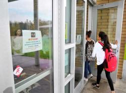 SETH GORDON - Newberg High School students use the main entrance on the north side of campus, which is now locked during school hours, requiring visitors to be buzzed in by the main office. The school district hired a consultant to do a security audit and is working to establish procedures that will mitigate risks at its buildings.