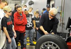 GRAPHIC PHOTO: SETH GORDON - Clackamas Community College instructor Les Blahuta shows Newberg High School students how to balance a tire at the World of Speed auto shop in Wilsonville.