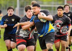 SETH GORDON - Junior Prop Anthony Ramirez breaks a tackle during Newberg's 24-14 win over Union (Wash.) in a state semifinal Saturday at Delta Park in Portland. The Tigers will face the Portland Pumas for the state championship at 3:30 p.m. Saturday at Western Oregon University in Monmouth.